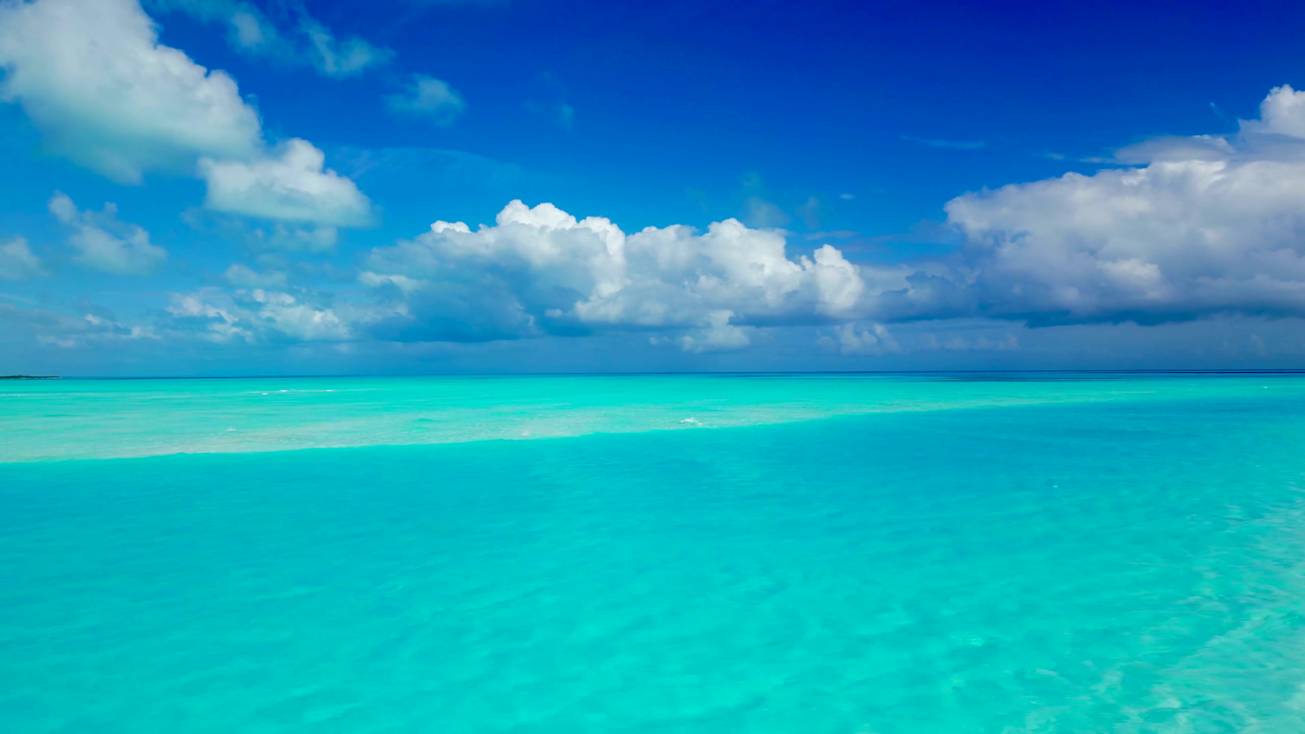 Turquoise lagoon under a bright cloudy sky